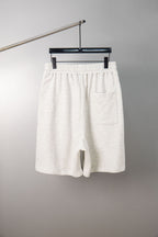 White shorts with elastic waistband, drawstring, and side pockets