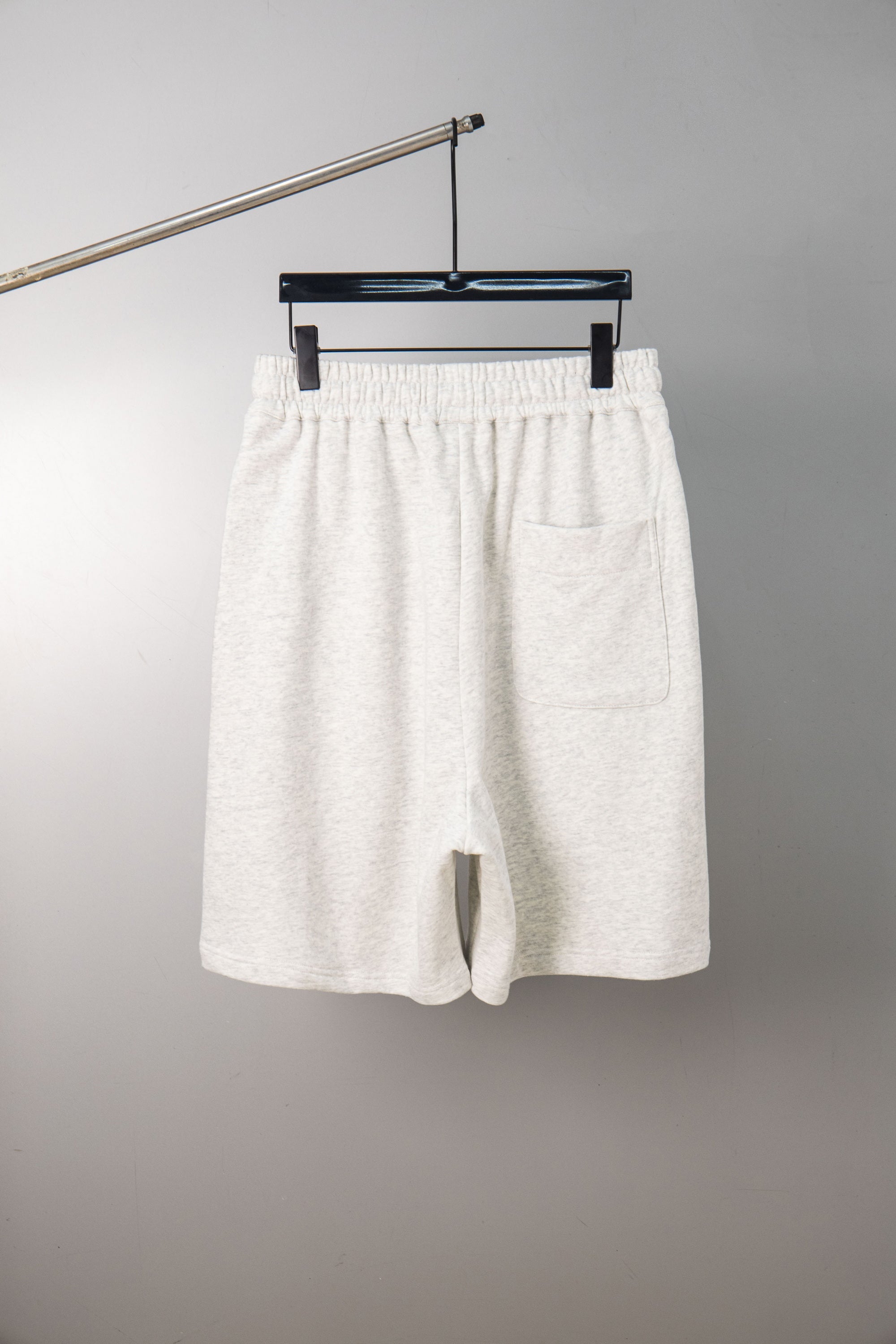 White shorts with elastic waistband, drawstring, and side pockets