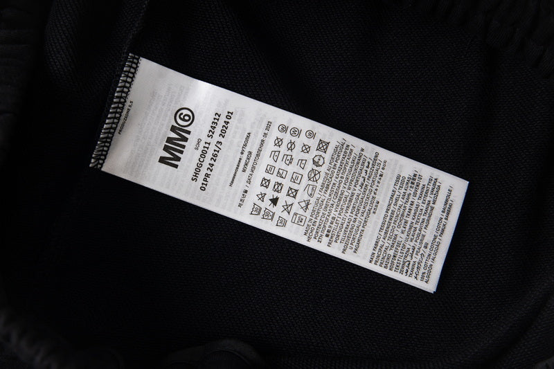 Maison Margiela clothing label on black fabric