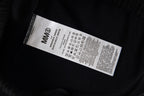 Maison Margiela clothing label on black fabric