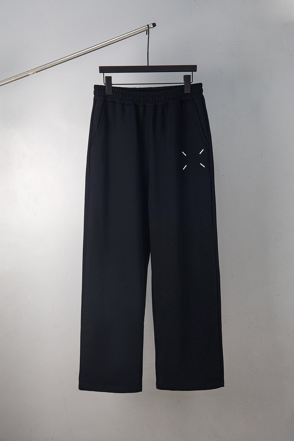 Black wide-leg trousers with embroidered 34/14 logo on front pocket