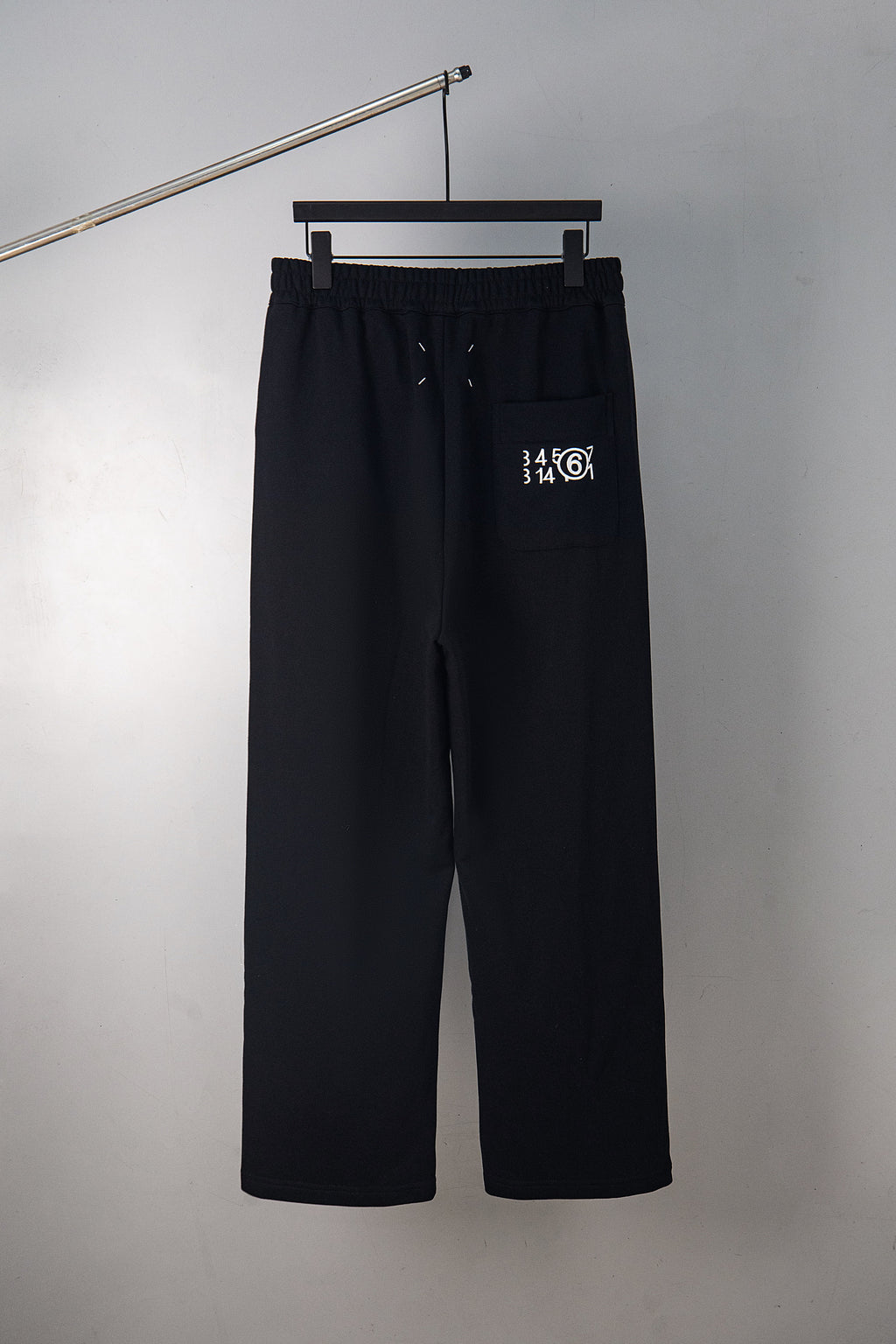 Black wide-leg trousers with 34/14 logo and side pocket detail