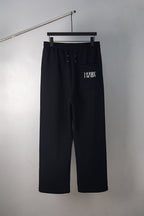 Black wide-leg trousers with 34/14 logo and side pocket detail