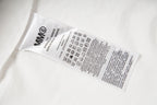White shirt care label with icons on inner seam