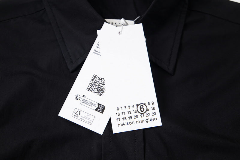Black button-up shirt with hang tag and Maison Margiela logo label