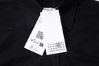 Black button-up shirt with hang tag and Maison Margiela logo label