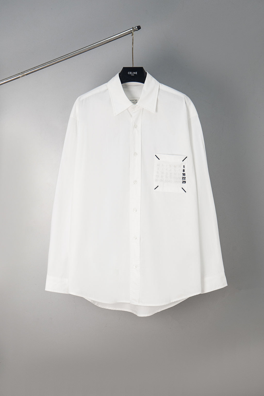 White button-up shirt with front logo graphic, long sleeves