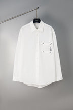 White button-up shirt with front logo graphic, long sleeves