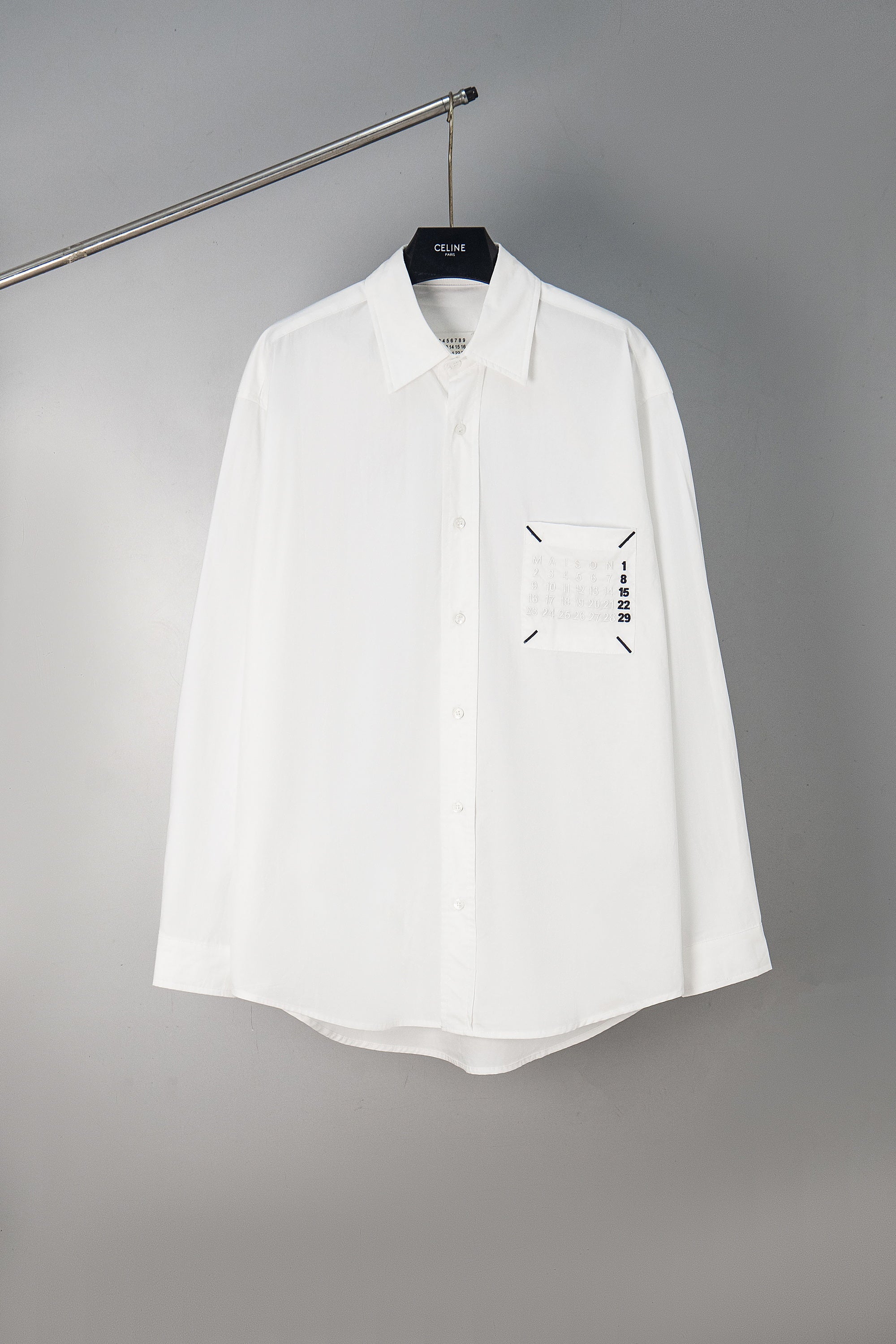 White button-up shirt with front logo graphic, long sleeves
