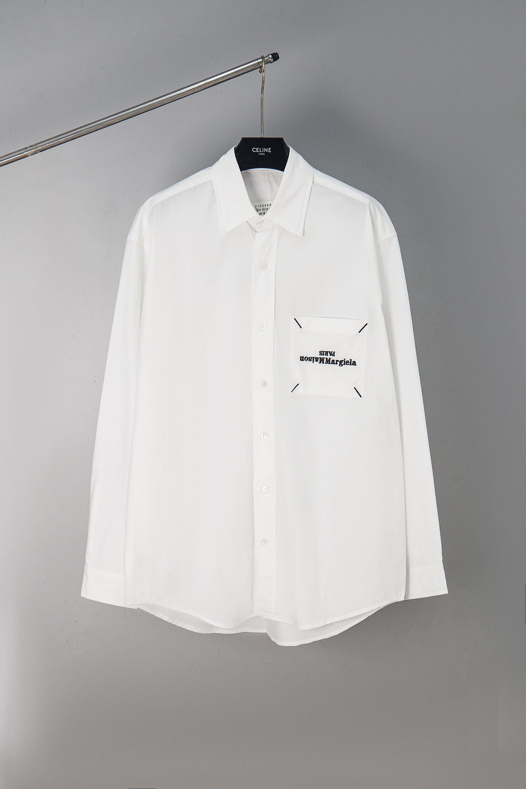 White button-up shirt with chest pocket and small Maison Margiela logo