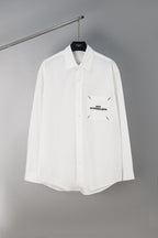 White button-up shirt with chest pocket and small Maison Margiela logo