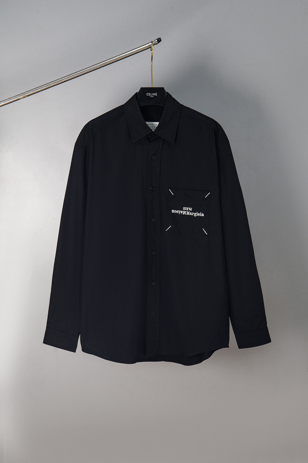 Dark navy button-up shirt with chest pocket and small Maison Margiela logo