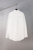 White button-up shirt, back view on hanger