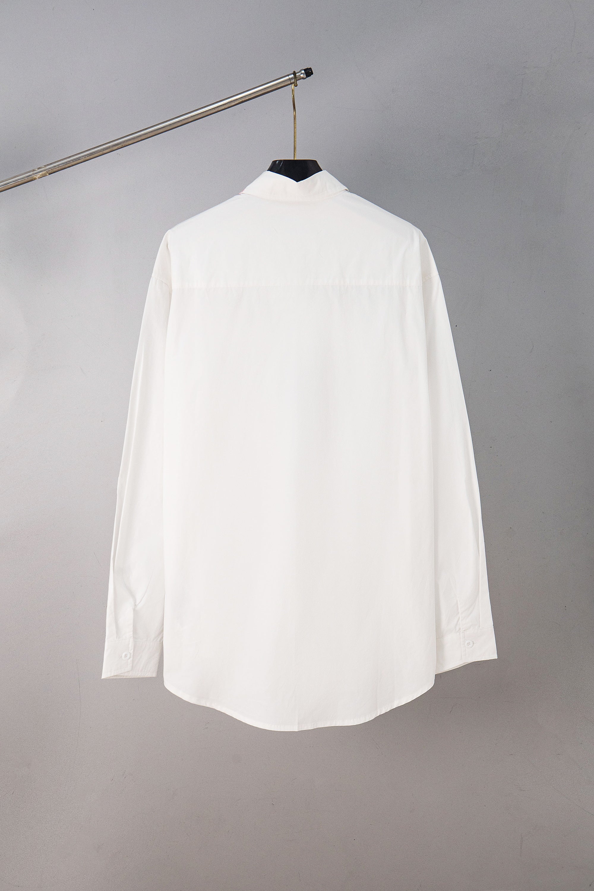 White button-up shirt, back view on hanger