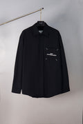 Black button-up shirt with pointed collar and chest logo detail