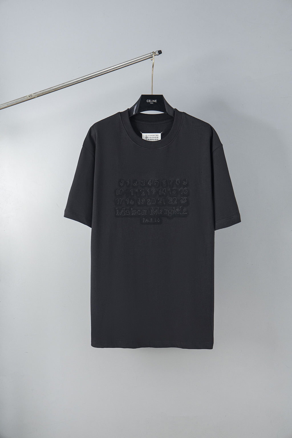 Black short-sleeve T-shirt with crew neck and embossed logo pattern