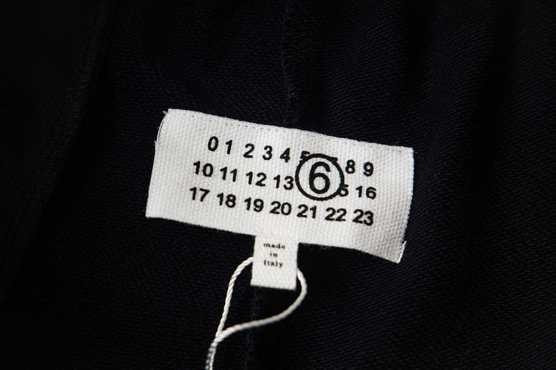 Black fabric size label with numbers and Maison Margiela logo