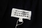 Black fabric size label with numbers and Maison Margiela logo