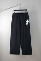 Dark wide-leg trousers with elastic waistband and hanging tag