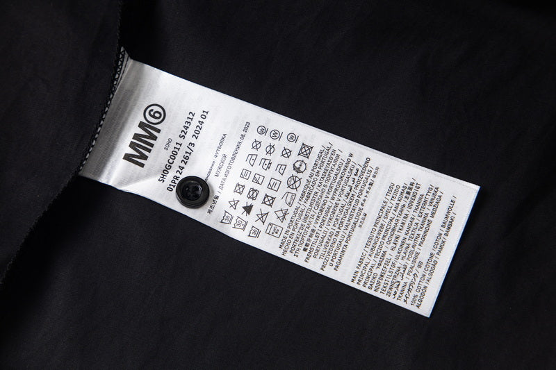 MM6 care label on black fabric