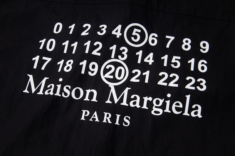 Dark shirt close-up with number graphic and Maison Margiela Paris text