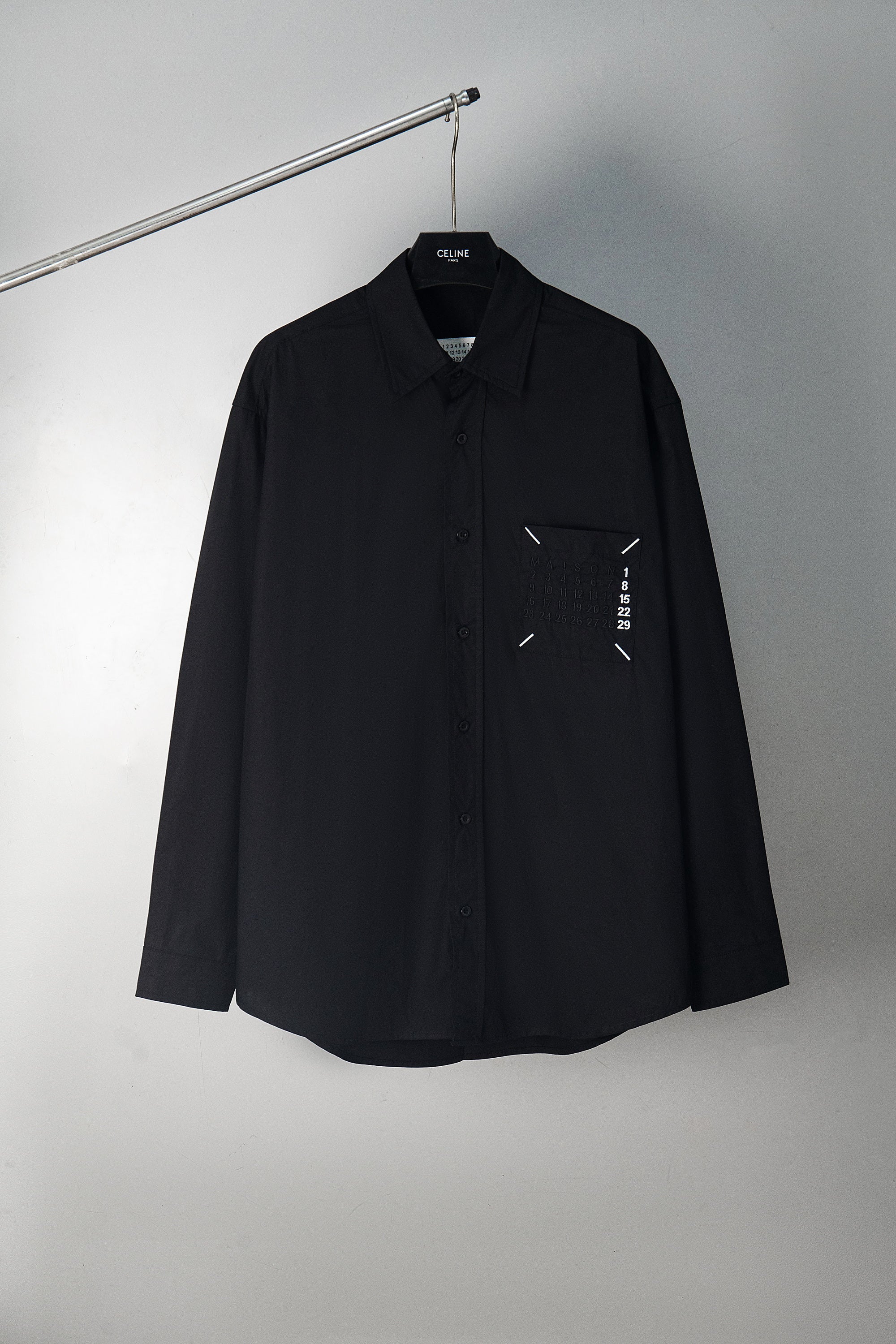 Black button-up shirt with front logo graphic, long sleeves