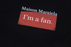 Black T-shirt close-up with 'I'm a fan' logo patch