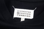 Black T-shirt neckline with white size label and number markings