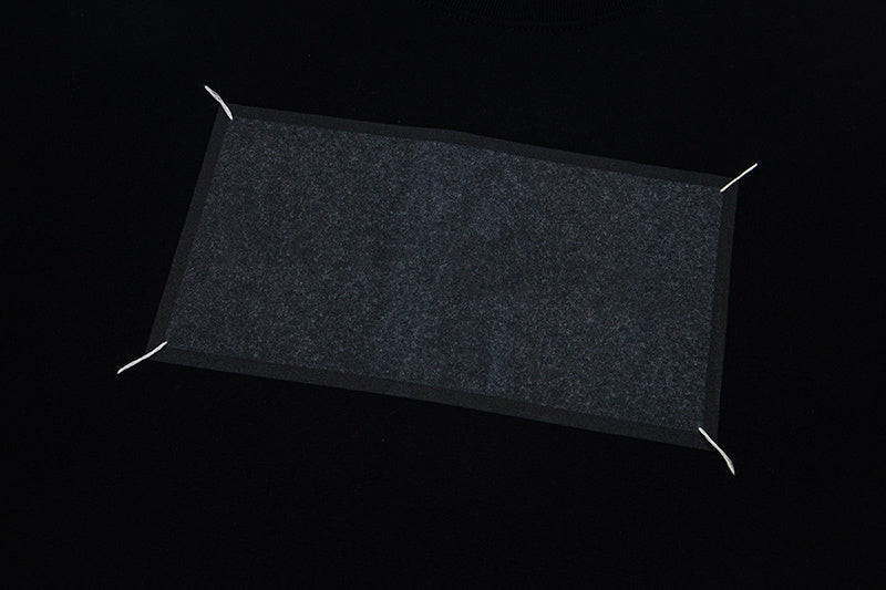 Gray rectangular graphic panel on a black T-shirt chest
