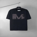 Black graphic T-shirt with large distressed M logo print