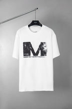 White graphic T-shirt with large distressed M logo print