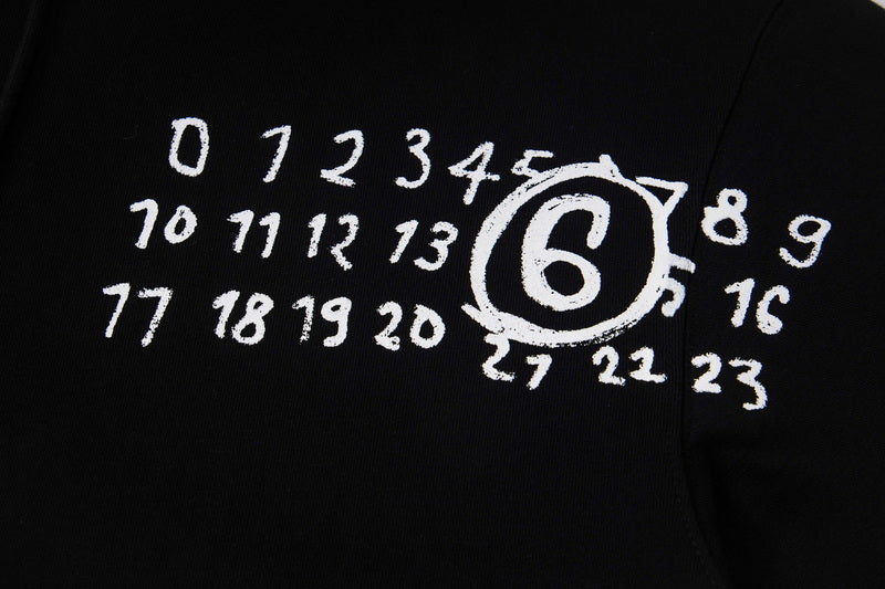Close-up of black hoodie with white printed number graphic and emblem