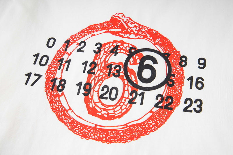 Close-up: white long-sleeve T-shirt chest print, red circular number emblem