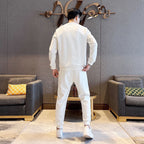 White tracksuit set with long-sleeve sweatshirt and jogger pants, back view