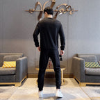 Black tracksuit set with long-sleeve sweatshirt and jogger pants, back view
