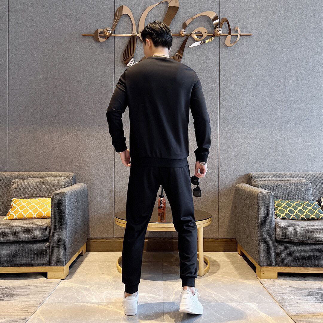 Black tracksuit set with long-sleeve sweatshirt and jogger pants, back view