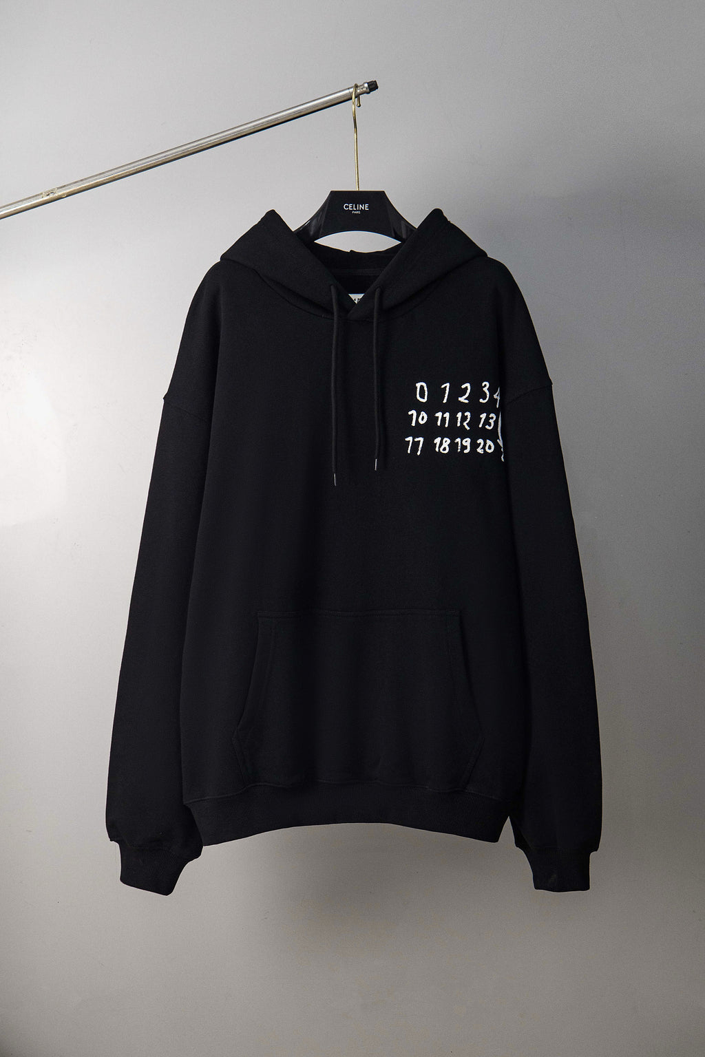 Black Maison Margiela pullover hoodie with drawstring hood and printed number logo