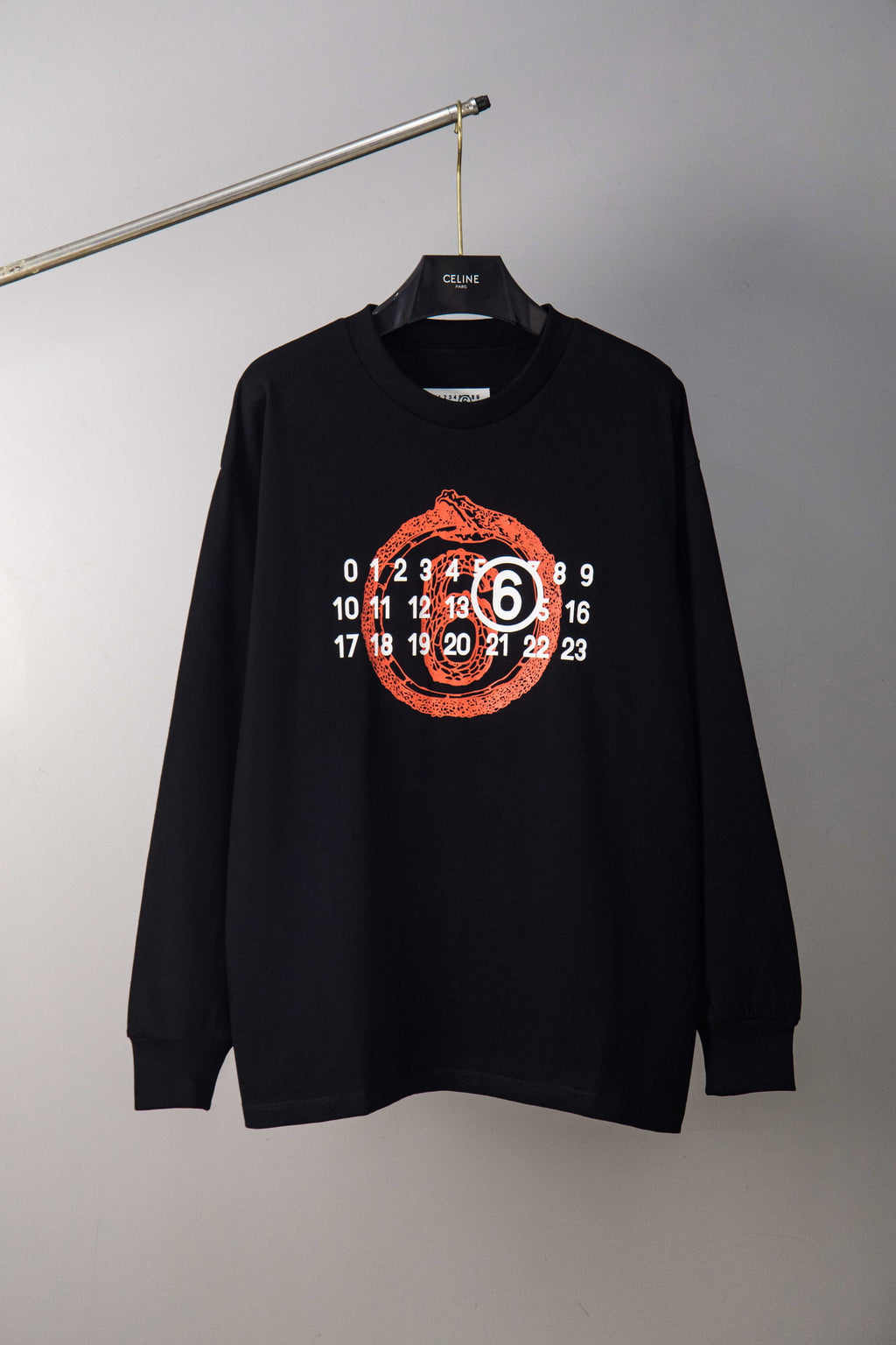 Black long-sleeve T-shirt with red and white number graphic on chest