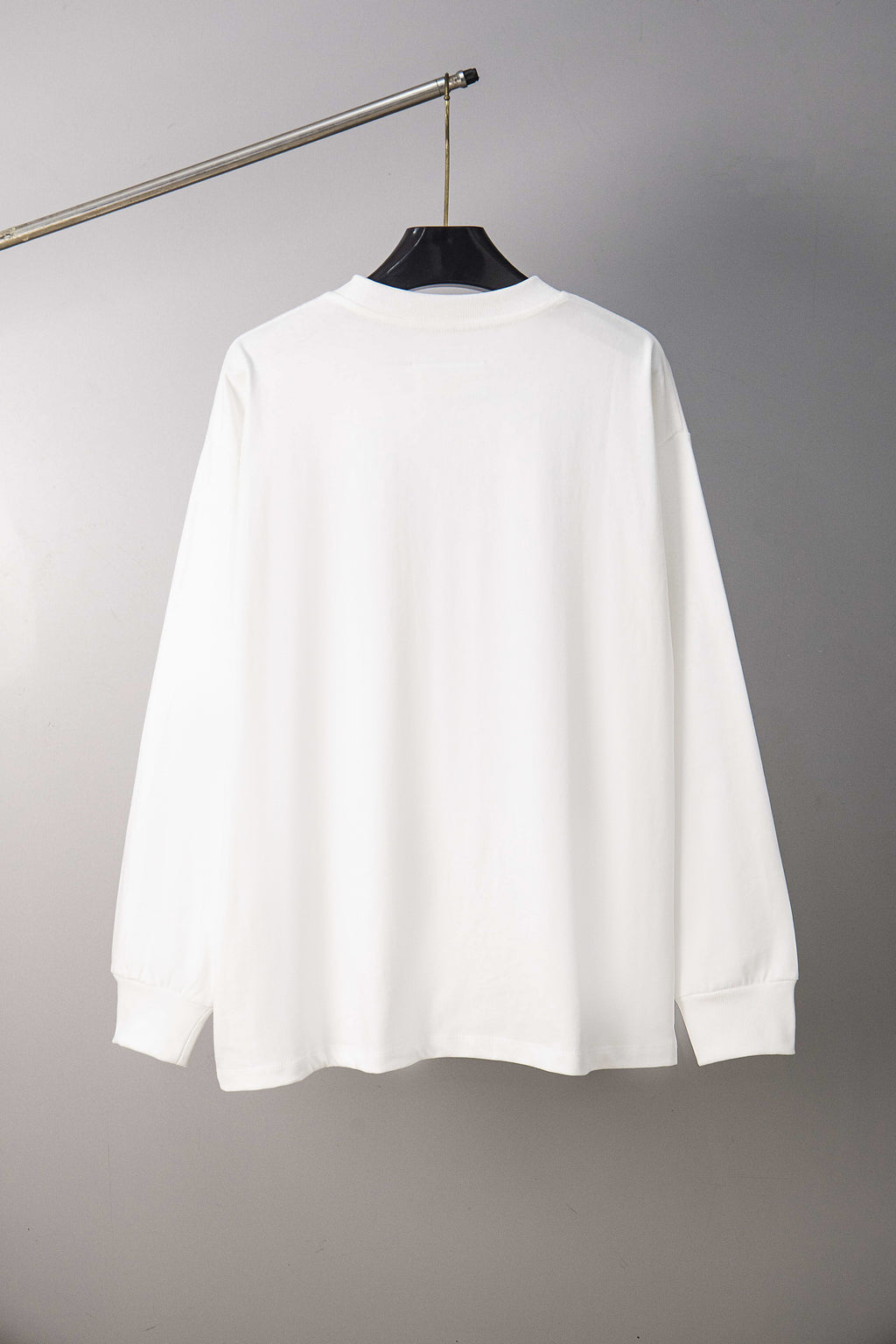 White long-sleeve T-shirt on hanger, crew neck