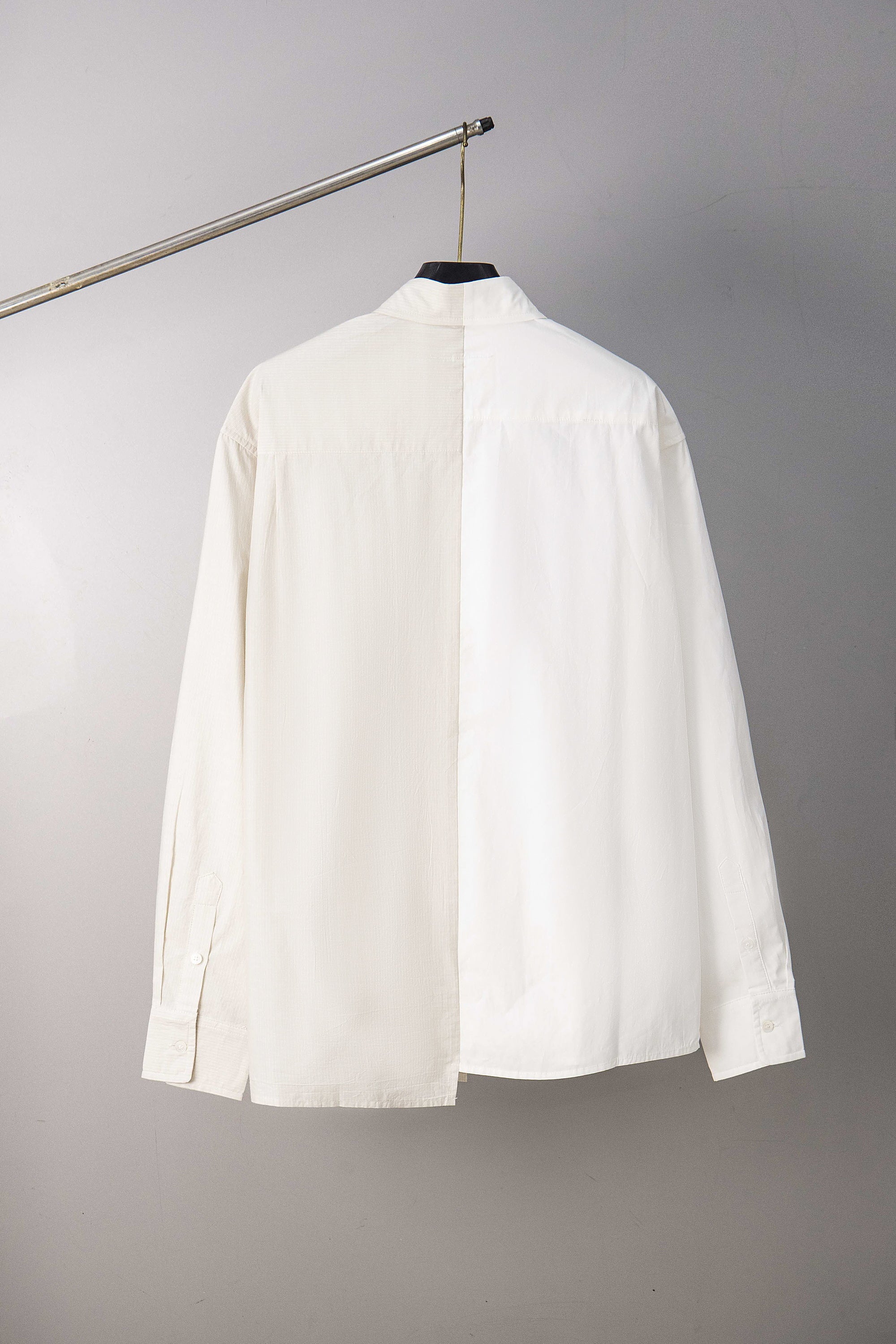 White button-up shirt back view with center seam and buttoned collar