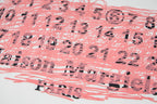 Pink and black numeric scribble graphic print on a white T-shirt front