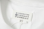 White T-shirt neckline label with small oval number graphic and brand text