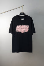 Black T-shirt with pink graphic logo print on the front, crew neck style