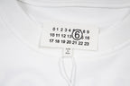 White T-shirt neckline with tag and SALOMON number 6 chest graphic