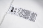 Garment care label with MM6 text and care instruction symbols
