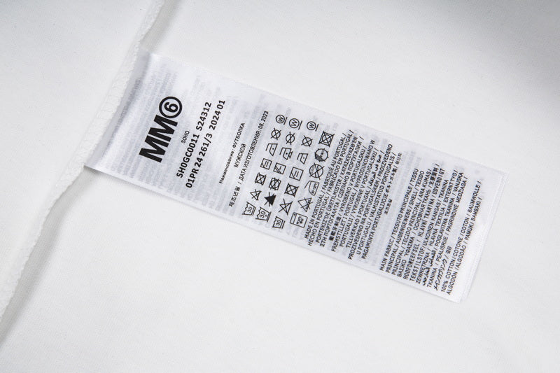 Garment care label with MM6 text and care instruction symbols