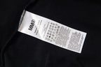 Black hoodie with interior care label on stitched tag