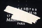 Black hoodie graphic with Maison Paris text and numbers 17–16