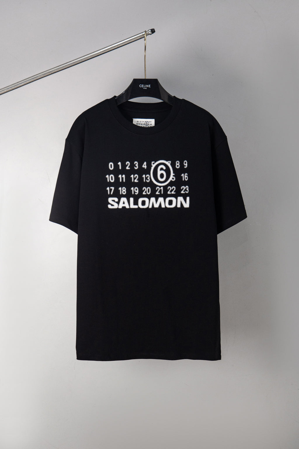 Black T-shirt with SALOMON graphic and number 6 print at chest