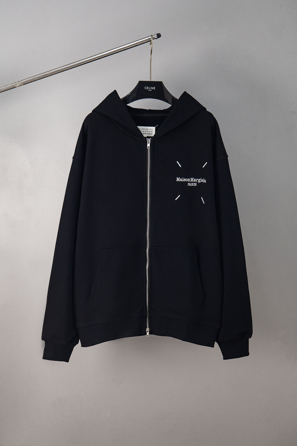 Black zip-up hoodie with hood and Maison Margiela chest logo